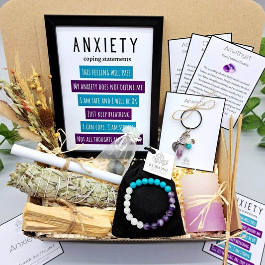 Anxiety gift box, containing print frame, white sage, palo santo, crystal bracelet, candle and other gift elements. Front look.