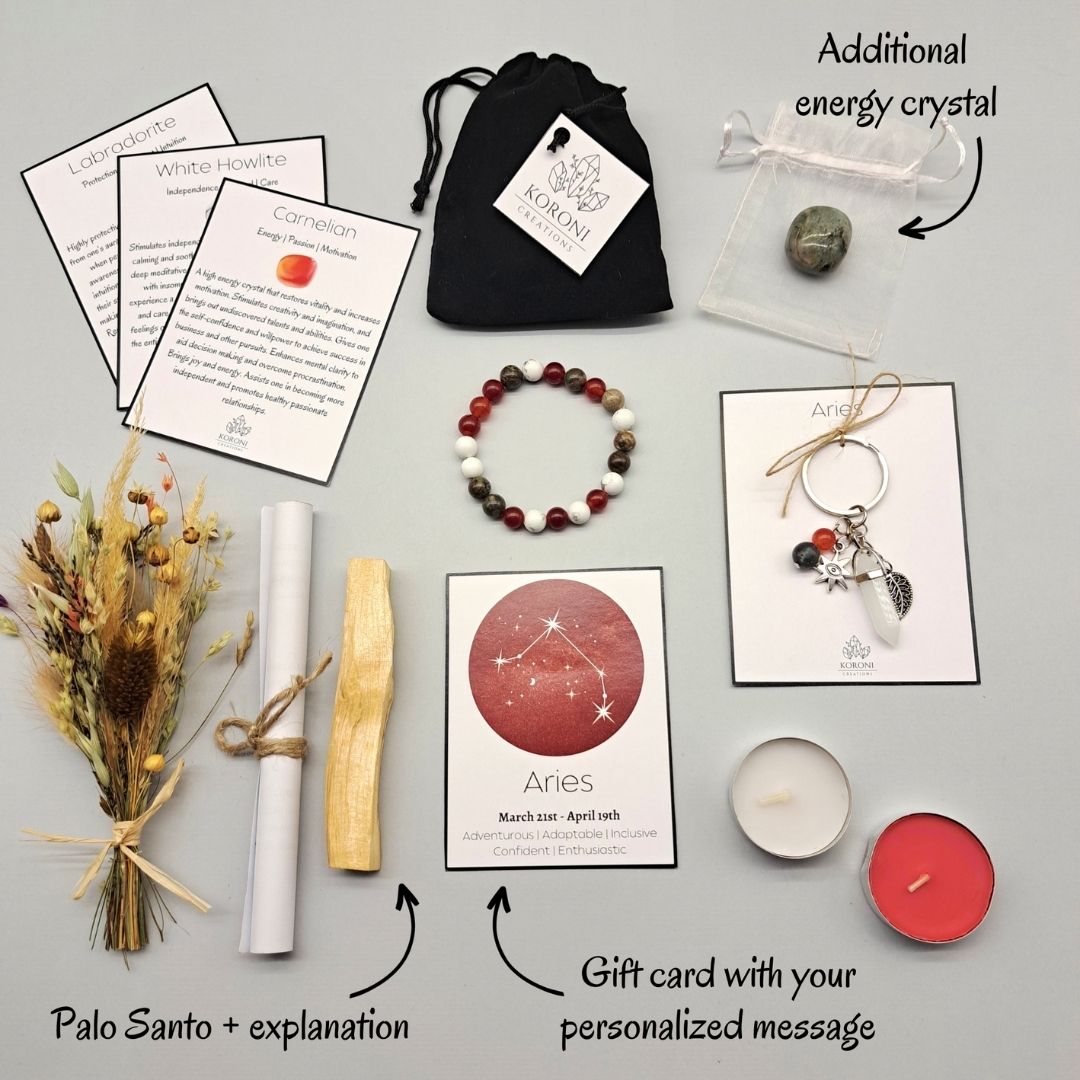 Products from an Aries gift set, placed outside the box on a surface. Crystal bracelet, keychain, flowers, aroma materials and other products and explanations for some of them.