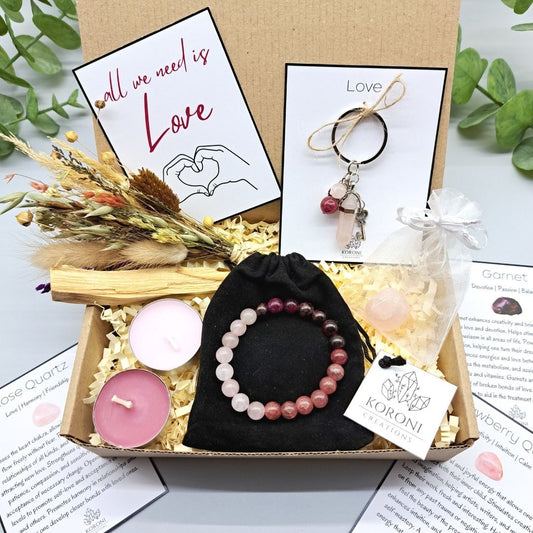 Love gift box, containing crystal bracelet, keychain, flowers, candles and other gift elements. Front look.