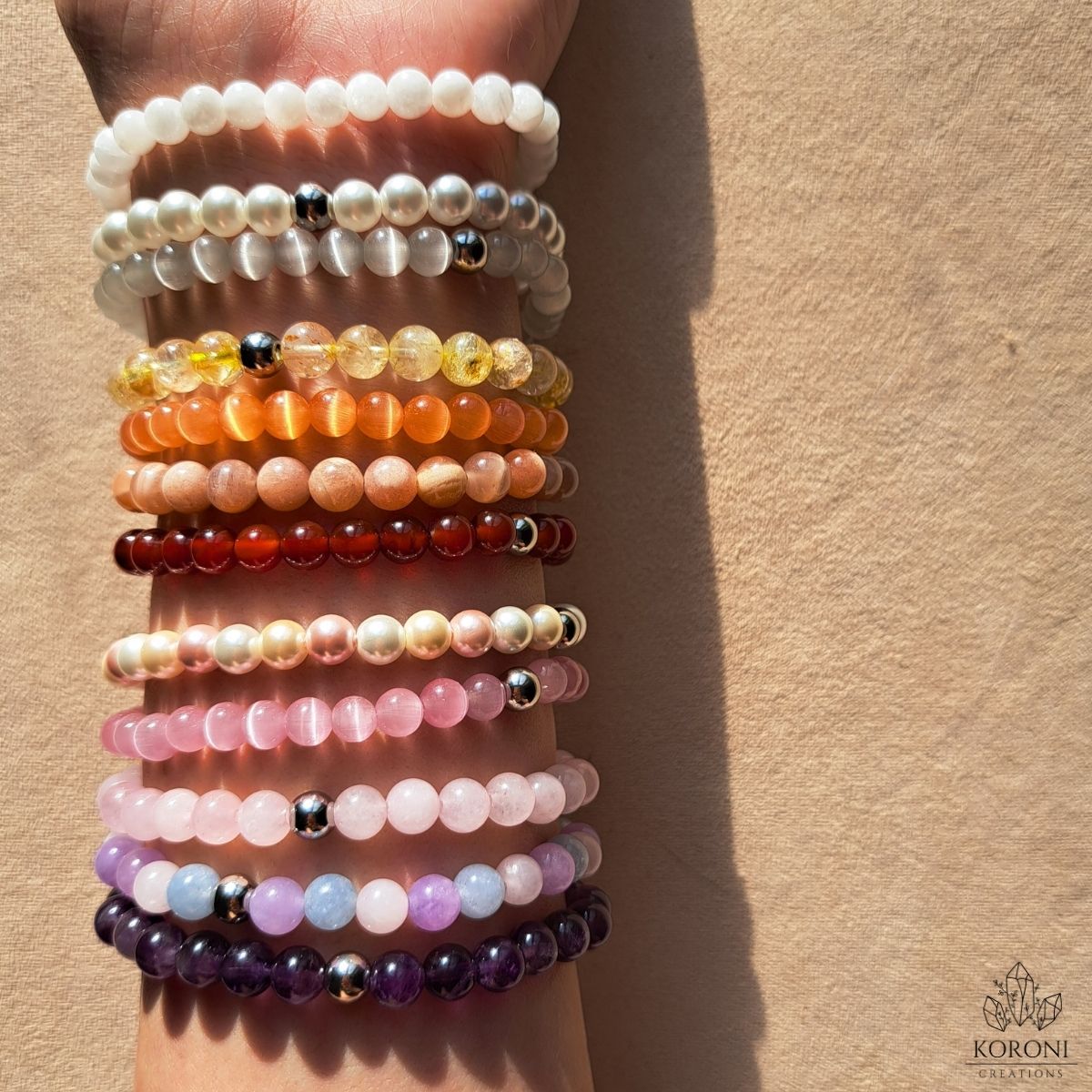 Gemstone bracelets on a wrist.