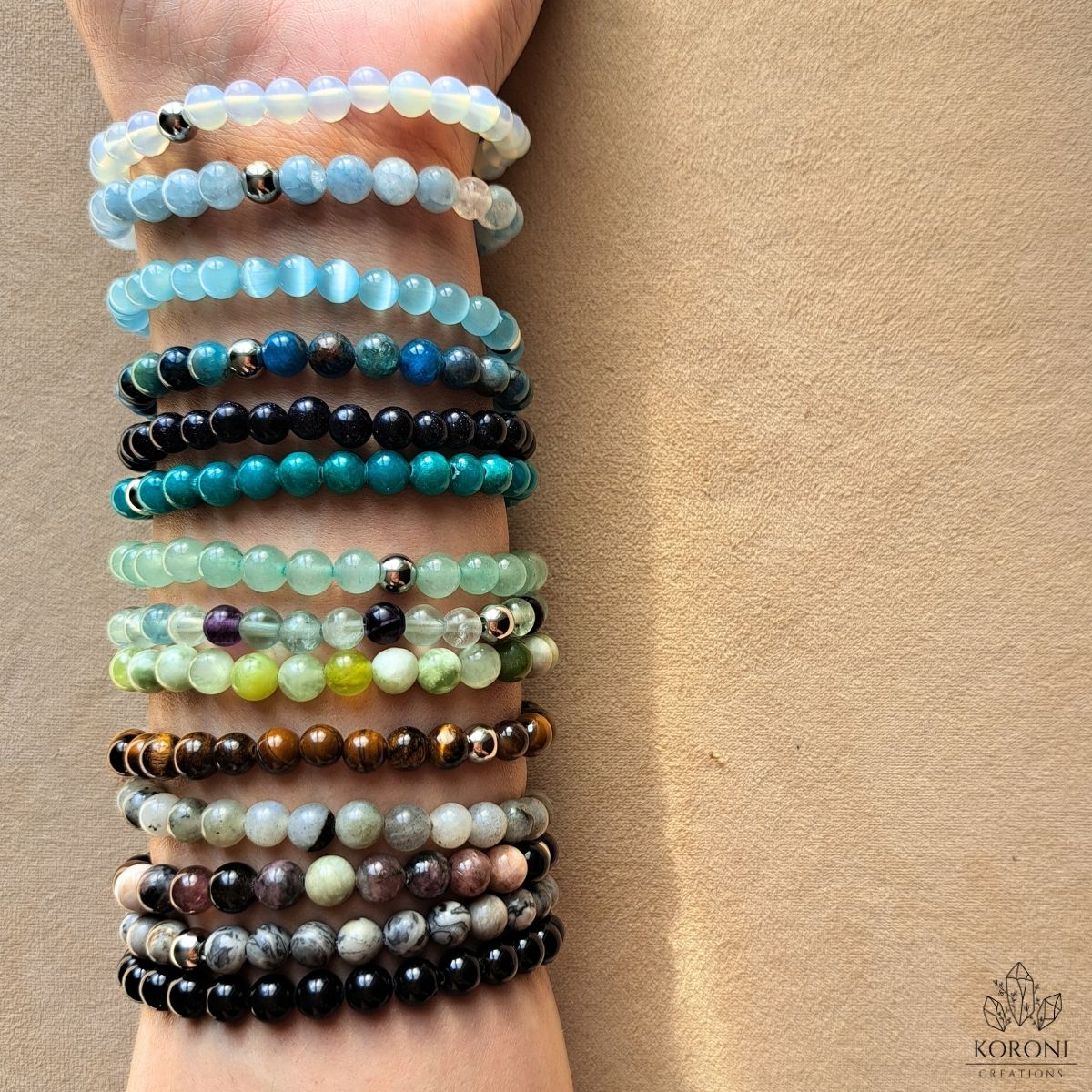 Gemstone bracelets on a wrist.