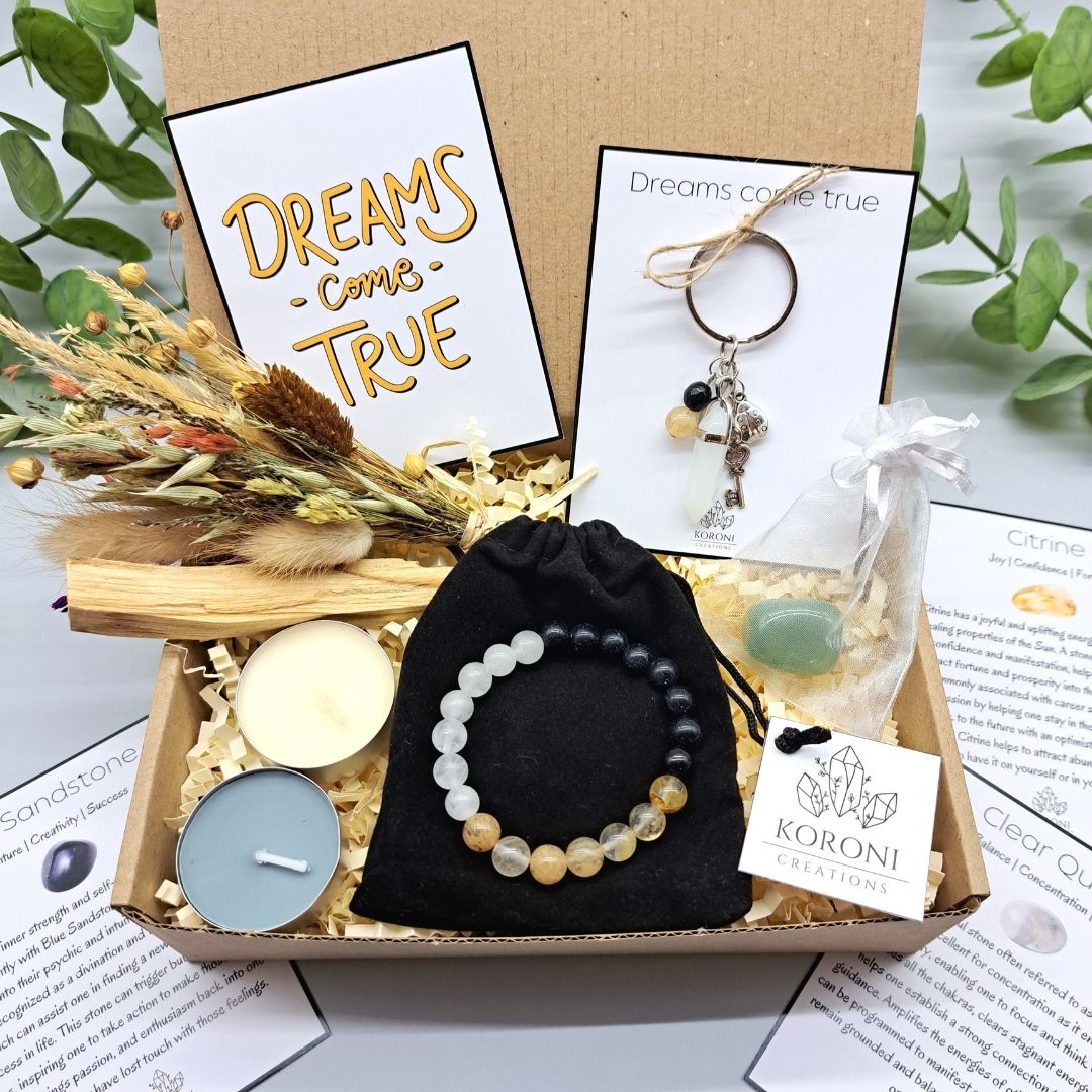 Wish your dreams come true gift box, containing crystal bracelet, keychain, flowers, candles and other gift elements. Front look.