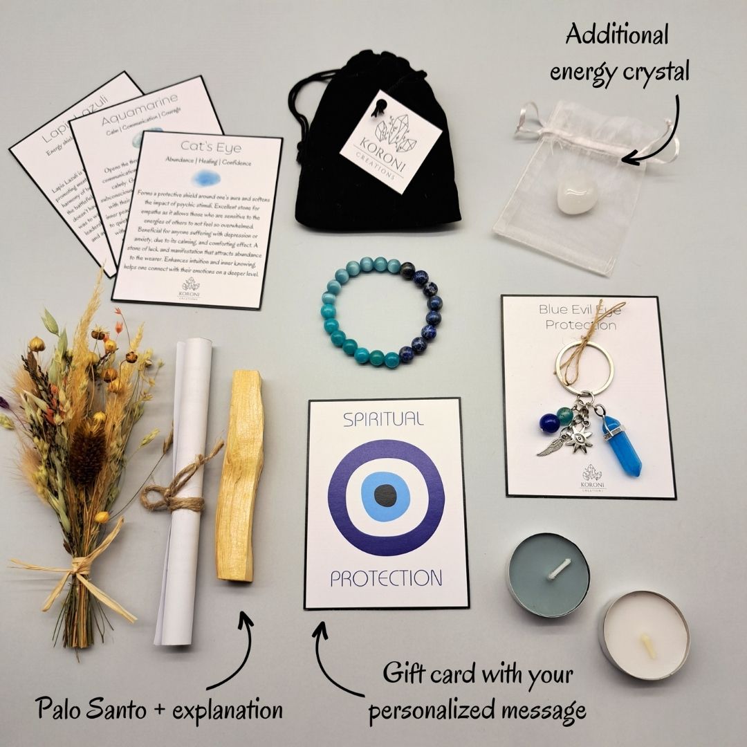 Products from a Evil eye protection box, placed outside the box on a surface. Crystal bracelet, keychain, flowers, aroma materials and other products and explanations for some of them.