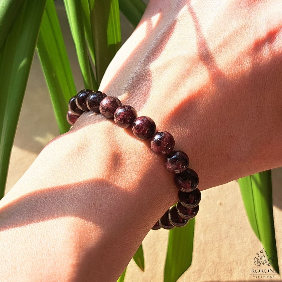 Garnet bracelet on a wrist.