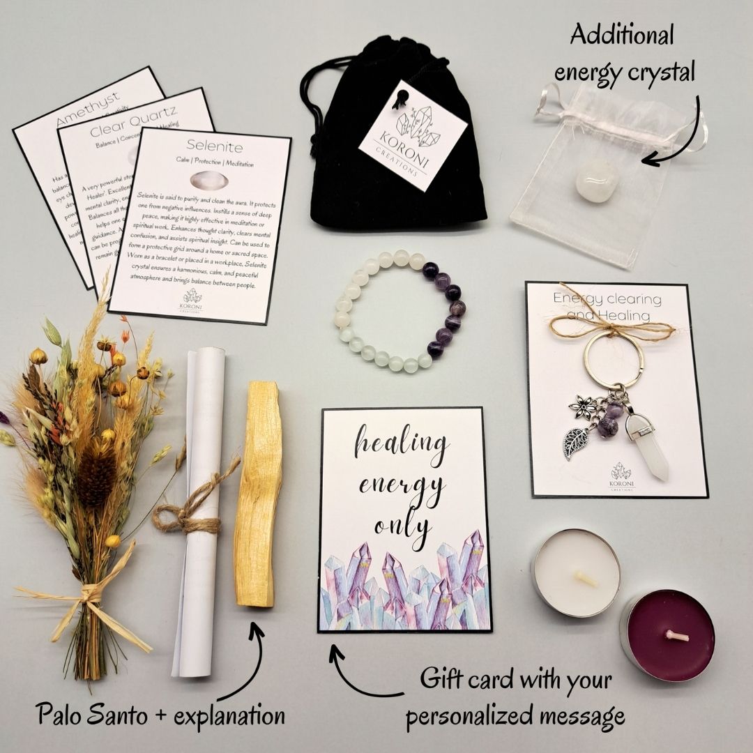 Products from a Healing energy gift box, placed outside the box on a surface. Crystal bracelet, keychain, flowers, aroma materials and other products and explanations for some of them.