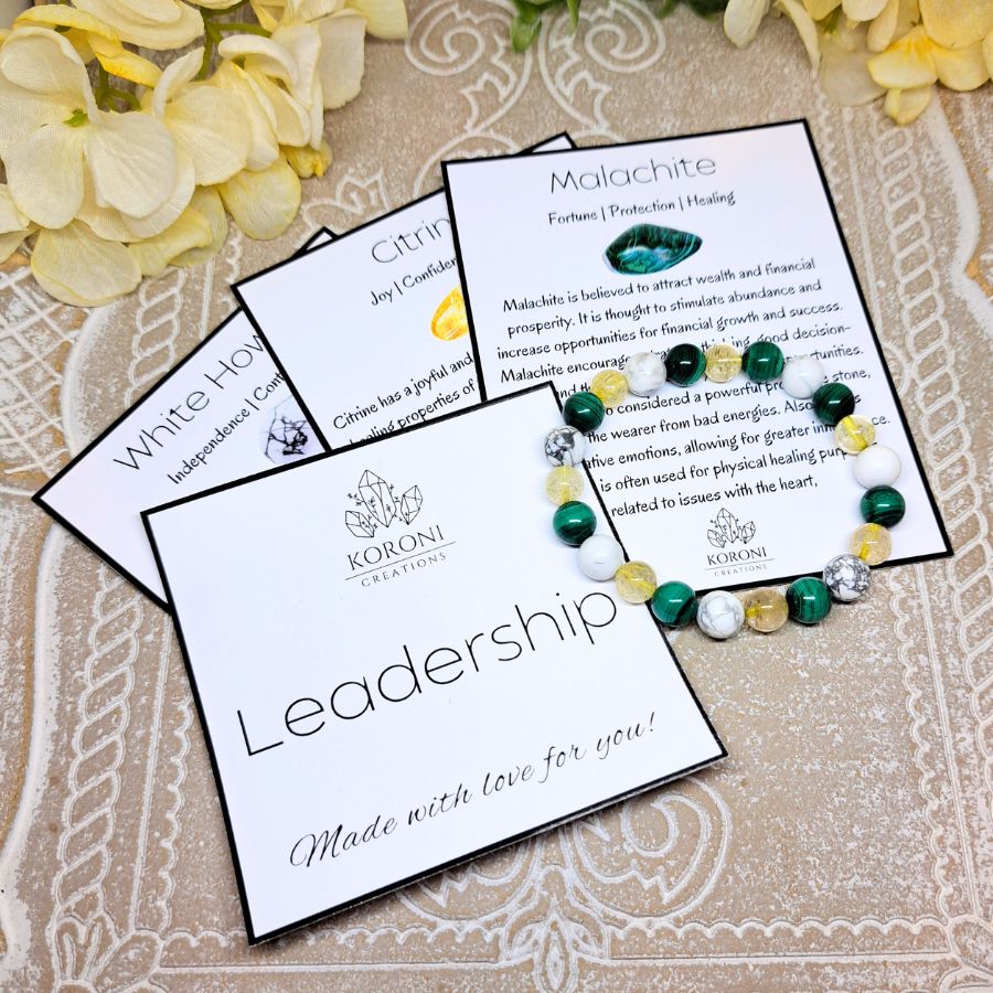 Green, yellow and white crystal bracelet over explanation cards.