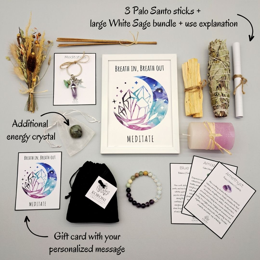 Products from a Meditation set, placed outside the box on a surface. Print in frame, crystal bracelet, keychain, aroma materials and other products and explanations for some of them.