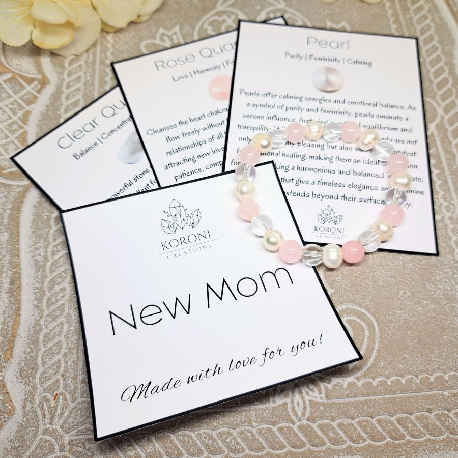 Pink and white beaded bracelet over explanation cards.