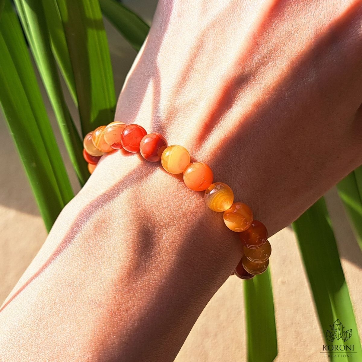 Orange Agate bracelet on a wrist.