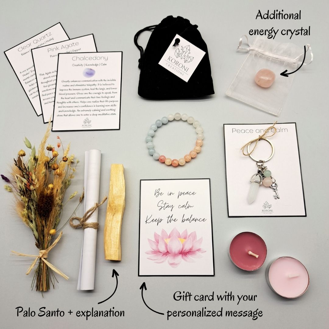 Products from a Peace and calm gift box placed outside the box on a surface. Crystal bracelet, keychain, flowers, aroma materials and other products and explanations for some of them.