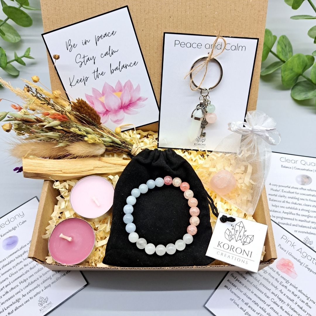 Peace and calm gift box, containing crystal bracelet, keychain, flowers, candles and other gift elements. Front look.