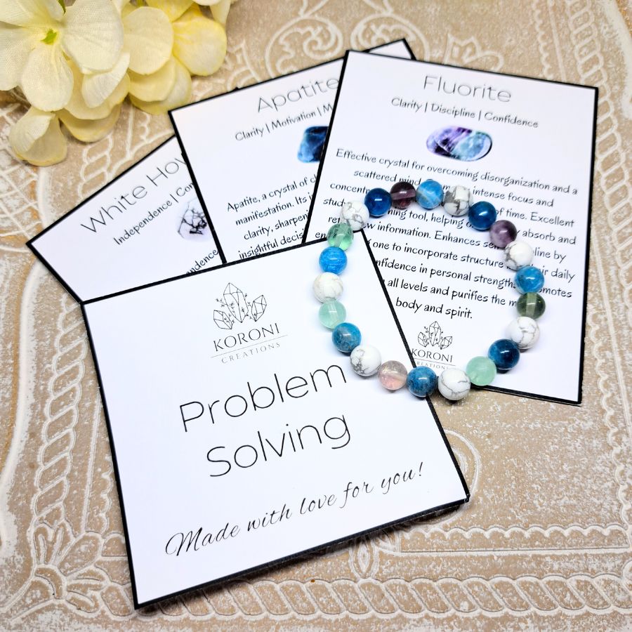 Blue and white beaded bracelet over explanation cards.