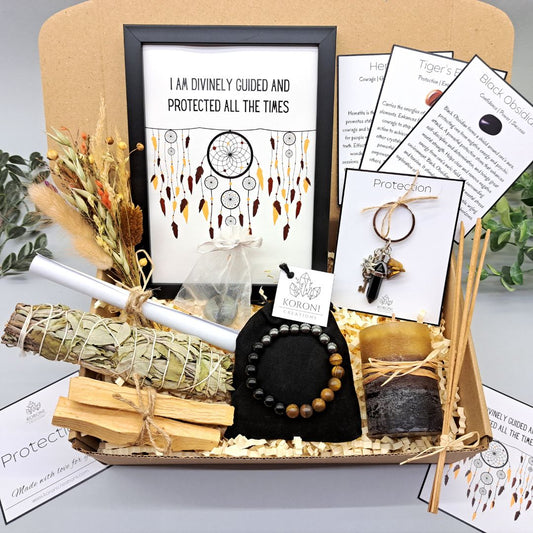 Protection gift box, containing print frame, white sage, palo santo, crystal bracelet, candle and other gift elements. Front look.