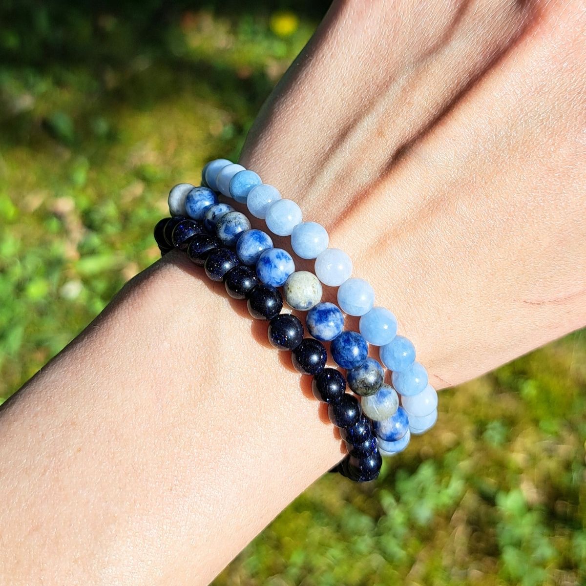 3 blue stone bracelets on a women wrist.