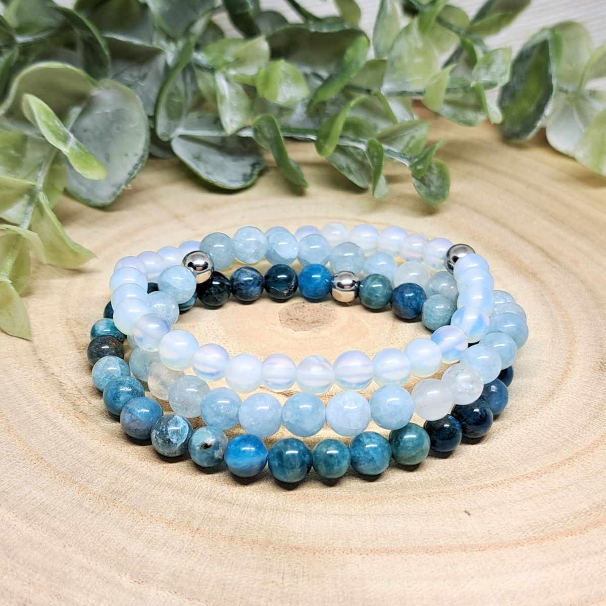 Light blue bracelets on a wood surface. 