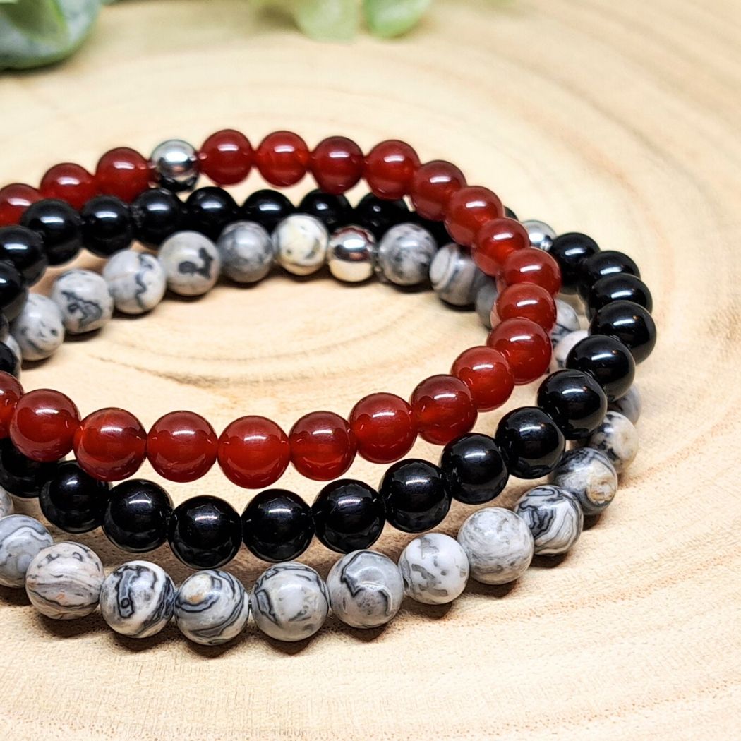 Red and black stone bracelets close look.