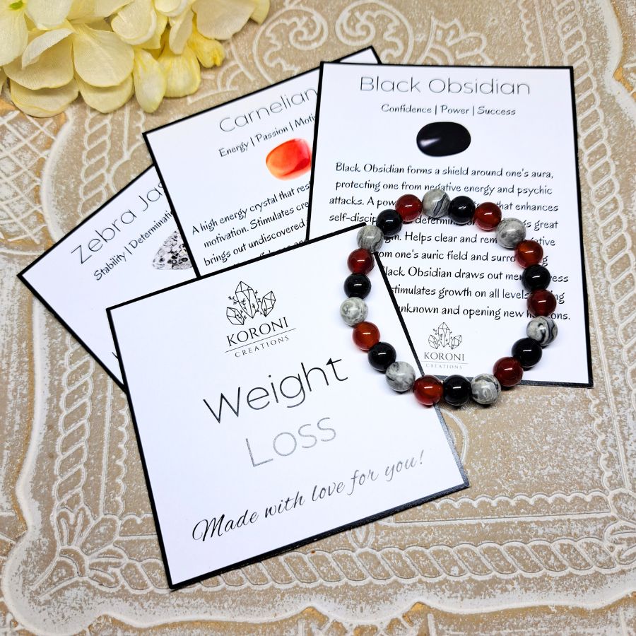 Black and red beaded bracelet over explanation cards.